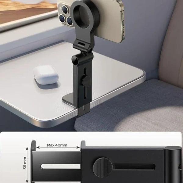 Airplane phone holder clipped to tray table with smartphone and wireless earbuds